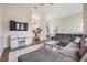 Open concept living room with a gray sectional sofa, decorative rug, and easy access to the kitchen at 501 Knights Run Ave # 6104, Tampa, FL 33602