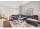 Spacious living room features a large gray sectional sofa, decorative rug, and access to the bathroom at 501 Knights Run Ave # 6104, Tampa, FL 33602