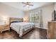 Cozy main bedroom with wood flooring, natural light, and ceiling fan at 501 Knights Run Ave # 6104, Tampa, FL 33602