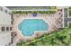 Aerial view of a community pool with lounge chairs, umbrellas, and detailed brickwork around the pool area at 501 Knights Run Ave # 6104, Tampa, FL 33602