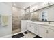 Modern bathroom with a walk-in shower, double vanity, and elegant fixtures throughout at 527 Bay St, Dunedin, FL 34698