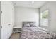 Bedroom featuring a cozy bed, nightstand, and a window with natural light at 527 Bay St, Dunedin, FL 34698