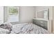 Bedroom featuring a cozy bed, dresser, and a window with natural light at 527 Bay St, Dunedin, FL 34698