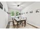 Dining room with a wooden table, six chairs, and natural light at 527 Bay St, Dunedin, FL 34698