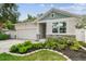Charming home with a manicured lawn, stone accents, and a welcoming entrance at 527 Bay St, Dunedin, FL 34698