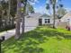 Charming home showcasing a manicured lawn, stone accents, and a welcoming two-car garage at 527 Bay St, Dunedin, FL 34698