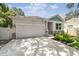 Charming home with a manicured lawn, stone accents, and a welcoming two-car garage at 527 Bay St, Dunedin, FL 34698