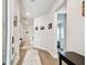 The hallway features wood floors, neutral walls adorned with art, and entryways to other rooms at 527 Bay St, Dunedin, FL 34698