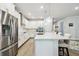 Stunning kitchen boasts stainless appliances, quartz countertops, and a breakfast bar for casual dining and entertaining at 527 Bay St, Dunedin, FL 34698