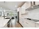 Bright kitchen with white cabinets, stainless steel appliances, and breakfast bar at 527 Bay St, Dunedin, FL 34698