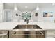 Modern kitchen island with stainless steel sink and pendant lighting at 527 Bay St, Dunedin, FL 34698