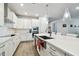 Bright kitchen featuring white cabinetry, stainless steel appliances, and an island with bar seating at 527 Bay St, Dunedin, FL 34698