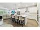 Spacious kitchen features a large island with seating and pendant lighting, seamlessly connecting to the living area at 527 Bay St, Dunedin, FL 34698