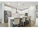 Modern kitchen featuring an island with bar seating, stainless steel appliances, and bright white cabinetry at 527 Bay St, Dunedin, FL 34698