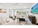 Bright living room with modern furniture, a ceiling fan, and natural light at 527 Bay St, Dunedin, FL 34698