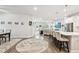 Open-concept living area with kitchen island seating, dining area, and comfortable lounge area at 527 Bay St, Dunedin, FL 34698