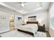 Bright main bedroom with a view to the bathroom, a tray ceiling, and modern décor at 527 Bay St, Dunedin, FL 34698