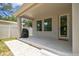 Covered outdoor patio featuring sleek design, brick extension, and easy access to the well-maintained yard at 527 Bay St, Dunedin, FL 34698