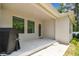 Covered patio with a seamless transition to a lush lawn and garden, perfect for outdoor enjoyment at 527 Bay St, Dunedin, FL 34698