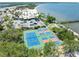 Aerial view showcasing community tennis and pickle ball courts near the beach, pier, and water views at 611 Destiny Dr # 509, Ruskin, FL 33570