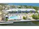 Aerial view of waterfront condo, pool, and pier featuring a beautiful and scenic waterfront community at 611 Destiny Dr # 509, Ruskin, FL 33570