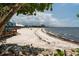 Expansive beachfront view with white sand leading to a charming beachfront restaurant on a sunny day at 611 Destiny Dr # 509, Ruskin, FL 33570