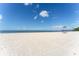 Wide sandy beach with clear blue sky and water, perfect for a relaxing day at 611 Destiny Dr # 509, Ruskin, FL 33570