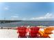 Relaxing beach view with colorful chairs overlooking the water and pier at 611 Destiny Dr # 509, Ruskin, FL 33570