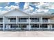 Bright exterior view of the waterfront condo building with balconies, parking, and manicured landscaping at 611 Destiny Dr # 509, Ruskin, FL 33570