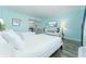 Bright main bedroom featuring two beds, TV, and partial kitchen view at 611 Destiny Dr # 509, Ruskin, FL 33570