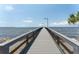 Long pier stretching into the calm water, enhanced by modern lighting and sturdy railing at 611 Destiny Dr # 509, Ruskin, FL 33570