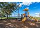 A playground with slides and climbing equipment with mature shade trees at 611 Destiny Dr # 509, Ruskin, FL 33570