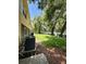 Spacious backyard featuring lush green lawn, privacy fence and mature trees at 6333 Maisie Rd, Zephyrhills, FL 33542
