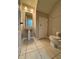 Clean half-bath featuring a pedestal sink, toilet, neutral tile flooring, and a wall mirror at 6333 Maisie Rd, Zephyrhills, FL 33542