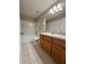 Bathroom featuring a tiled floor, a vanity with cabinet storage, and a shower and tub combo at 6333 Maisie Rd, Zephyrhills, FL 33542