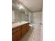 Bathroom features a vanity, toilet, and shower with bathtub at 6333 Maisie Rd, Zephyrhills, FL 33542
