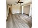 Bedroom with a fan, closet, and wood-look flooring at 6333 Maisie Rd, Zephyrhills, FL 33542