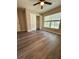 Bedroom featuring new flooring, a ceiling fan, a closet, and natural light from the window at 6333 Maisie Rd, Zephyrhills, FL 33542