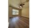 Bedroom with new flooring, ceiling fan, closet, and natural light from the window at 6333 Maisie Rd, Zephyrhills, FL 33542