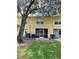 Rear exterior view showcasing screened patio with access doors, and beige siding at 6333 Maisie Rd, Zephyrhills, FL 33542