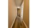 Hallway with updated flooring and neutral paint that provides access to various rooms at 6333 Maisie Rd, Zephyrhills, FL 33542