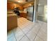 Kitchen with wood cabinets, tile flooring, stainless steel appliances, and ample counter space at 6333 Maisie Rd, Zephyrhills, FL 33542