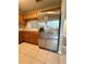 Kitchen features stainless steel refrigerator and tile flooring at 6333 Maisie Rd, Zephyrhills, FL 33542