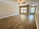 Spacious living room features wood-look floors, neutral walls, bright light, and ceiling fan at 6333 Maisie Rd, Zephyrhills, FL 33542