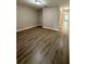 Large living space features wood-look flooring, neutral walls, and ample space at 6333 Maisie Rd, Zephyrhills, FL 33542