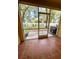 Enclosed patio area with tile flooring and a view of the lawn and fencing at 6333 Maisie Rd, Zephyrhills, FL 33542