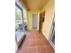 Enclosed patio area with tile flooring leading to the yard, and a glimpse of some landscaping at 6333 Maisie Rd, Zephyrhills, FL 33542