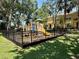 Community playground featuring play structures, swings, and safety fencing at 6333 Maisie Rd, Zephyrhills, FL 33542