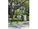 Eiland Park Townhomes signage featuring a decorative fence, and professional landscaping at 6333 Maisie Rd, Zephyrhills, FL 33542