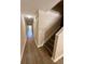Hallway and Stairway showing wood flooring and neutral colored walls at 6333 Maisie Rd, Zephyrhills, FL 33542